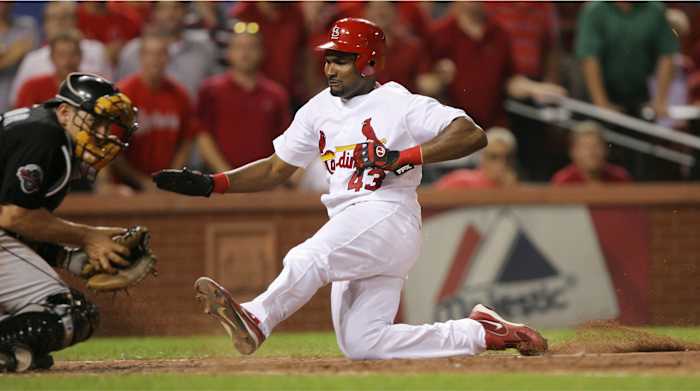 St. Louis Cardinals' Juan Encarnacion scores past Florida Marlins catcher Matt Treanor in the eighth inning at Busch Stadium in St. Louis, Missouri, Tuesday, August 21, 2007.